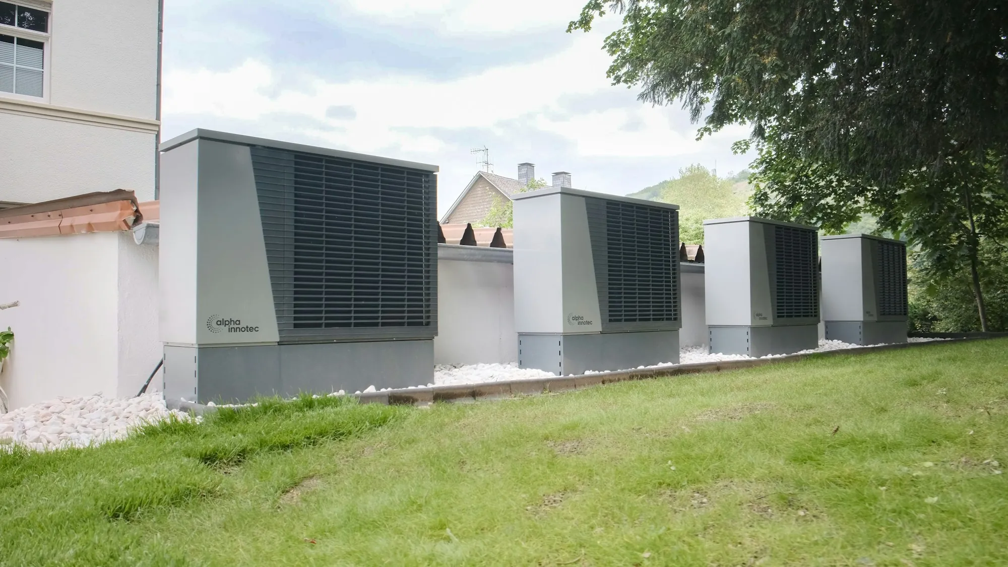 Large heat pump units on a green rooftop lawn