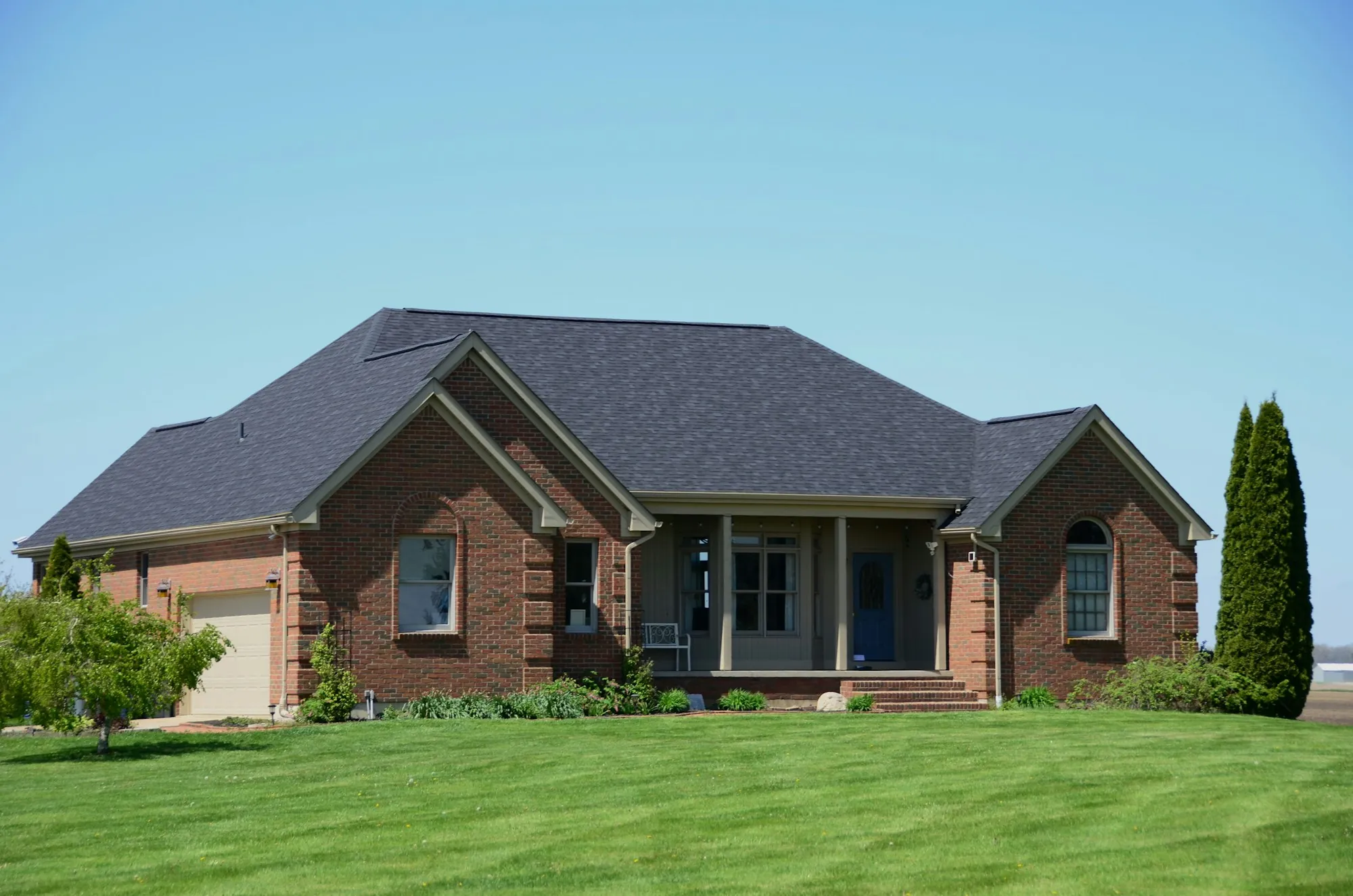 Brick ranch house with a hip roof and green lawn
